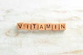 The inscription`VITAMIN` is laid out of wooden cubes.