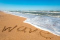 Inscription wave on the wet sand near sea Royalty Free Stock Photo