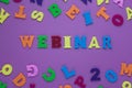 Inscription webinar on a purple background with multicolored letters. A word writing text showing concept of education