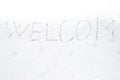 Inscription welcom on snow-covered ice Royalty Free Stock Photo