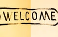 The inscription `Welcome` in black paint