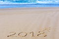 2018 inscription on wet beach sand and sea waves on background Royalty Free Stock Photo