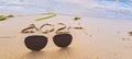 The inscription 2024 on the wet sand on the beach. Nearby are sunglasses Royalty Free Stock Photo