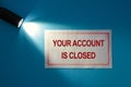 Inscription on a white card in the beam of light - Your account is closed