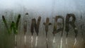 The inscription winter is painted on glass with condensation, the effect of fogged windows and glass. Royalty Free Stock Photo