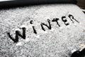 Inscription winter on snow on the back window