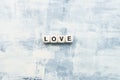 The inscription from wooden cubes LOVE on a light background. Gift concept for Valentine\`s day Royalty Free Stock Photo