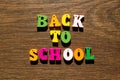 Inscription of the words of the slogan Back to school in multi-colored letters with shadow on a beautiful background