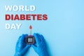 Inscription world diabetes day, Nurse making a blood test with red blood drop and Glucose meter Royalty Free Stock Photo