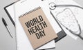 Inscription WORLD HEALTH DAY. Top view of the table with stethoscope,pen and medical documents. Health care concept Royalty Free Stock Photo