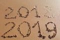 2018 2019 inscription written in the wet yellow beach sand being Royalty Free Stock Photo