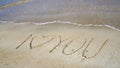 The inscription & x22;I love you& x22; on the sand near the sea Royalty Free Stock Photo