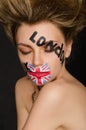 Inscriptions and flag of england on young woman`s face Royalty Free Stock Photo