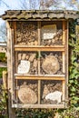 Insect hotel with small pieces of wood and wire mesh