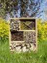 Insect house or dormitory for bugs, beetles, wasps, bumblebees, made of pipes, cones, twigs, perforated hemp for environmental