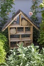 Insect house - hotel for the protection of biodiversity in a summer garden Royalty Free Stock Photo