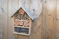 Insect house in summer garden Hotel for insects in wood background Royalty Free Stock Photo