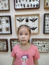The insectarium on the wall surprised the little girl very much. Emotions.