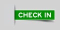 Inserted green sticker label with word check in on gray background