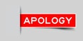 Inserted red sticker with word apology on gray background