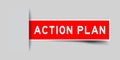 Inserted red sticker label with word action plan on gray background