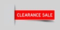 Inserted red sticker label with word clearance sale on gray background