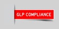 Inserted red sticker label with word GLP Good Laboratory Practice compliance on gray background