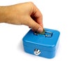 Inserting coin in blue money box