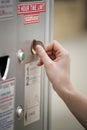 Inserting a coin into the parking meter. Conceptual image shot Royalty Free Stock Photo