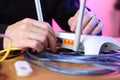 Inserting an internet cable into the router port on a table with cables by a person Royalty Free Stock Photo