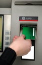 Inserting plastic card visa into ATM