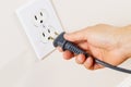 Inserting Power Cord Receptacle in wall outlet Royalty Free Stock Photo