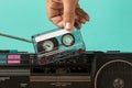 Inserting tape into cassette. High quality and resolution beautiful photo concept Royalty Free Stock Photo