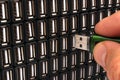 Hand inserting USB flash drive in one of many sockets Royalty Free Stock Photo