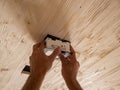 Insertion of square lamp on wooden ceiling