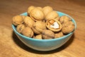 Inshell walnuts in a bowl. A full bowl of walnuts Royalty Free Stock Photo