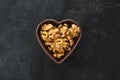 Inshell walnuts in a heart-shaped plate. Heart Nuts, Heart Health Products, Structured Walnuts Healthy food protein Royalty Free Stock Photo