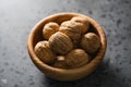 Inshell walnuts in olive wood bowl on terrazzo countertop Royalty Free Stock Photo