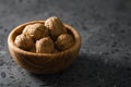 Inshell walnuts in olive wood bowl on terrazzo countertop Royalty Free Stock Photo