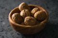 Inshell walnuts in olive wood bowl on terrazzo countertop Royalty Free Stock Photo