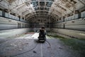 Inside Abandoned, Derelict Swimming Pool with Young Explorer Sitting on the Edge of the Pool Royalty Free Stock Photo