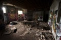 Inside an abandoned WWII concrete casemate with graffiti and the skeleton of a metallic bed on the French Atlantic coast