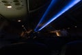 Inside airplane, closed overhead bin, blue lights dimmed in the aisle of an airplane Royalty Free Stock Photo