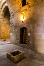 An inside hall and a former prison cell door in Paphos Castle