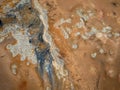 Inside a big volcano crater with gray white smoke, aerial view