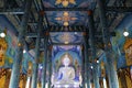 Inside the blue church is decorated with Thai art and white Buddha statue