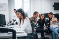 Inside of call center. Young business people working together in the modern office Royalty Free Stock Photo
