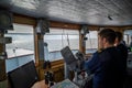 Inside the Captain`s bridge of passengers ship with blurred figures of staff