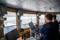 Inside the Captain`s bridge of passengers ship with blurred figures of staff one early autumn