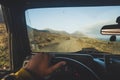 Inside a car driving point of view for outdoor widl travel concept with off road vehicle - beautiful landscape with ocean and Royalty Free Stock Photo